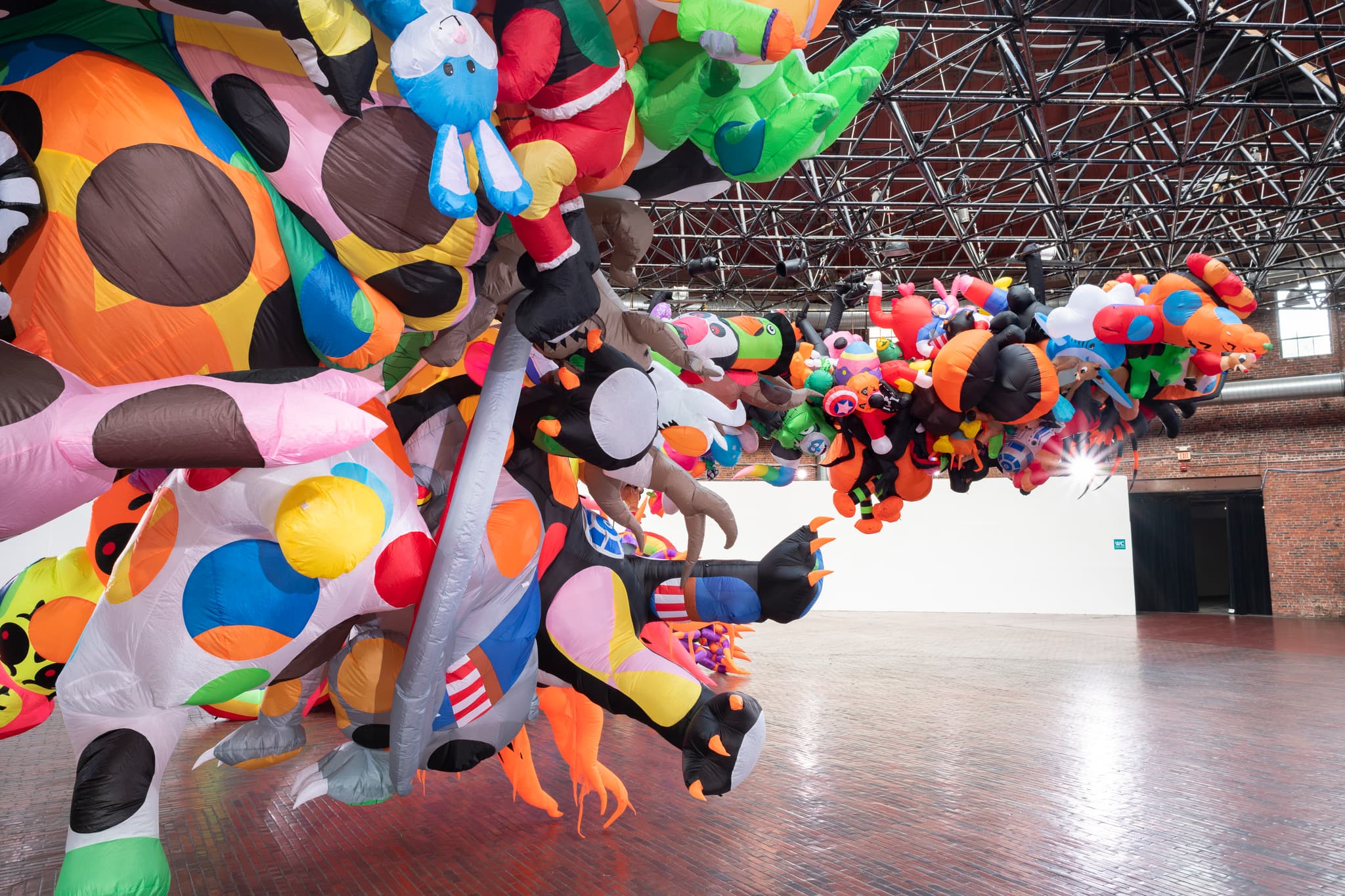 An abundance of colorful, inflatable figures hanging in the Cyclorama.