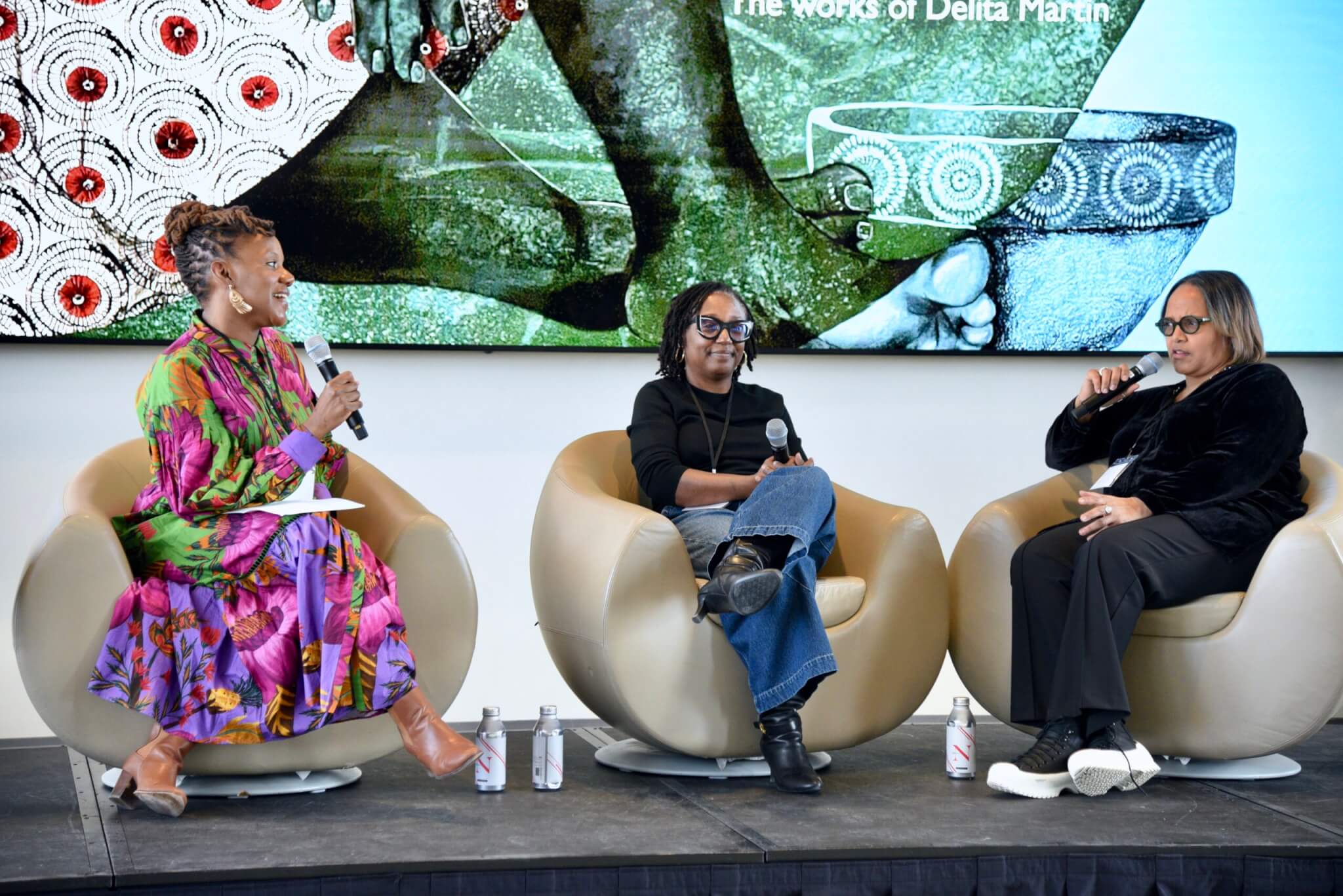 Three women participating in a panel discussion.